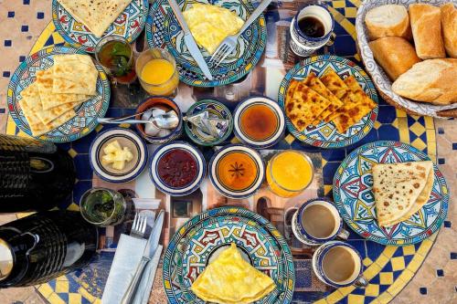a table topped with plates of food and drinks at Hotel Larayhana in Fez