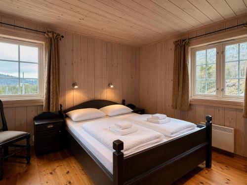 a bedroom with a large bed with two towels on it at Spacious cabin in Hemsedal, 8 bedrooms and sauna in Hemsedal