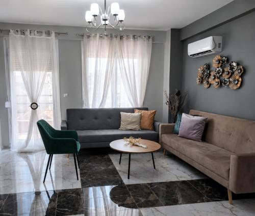 a living room with a couch and a table at Duba Apartments 2 in Alexandroupoli