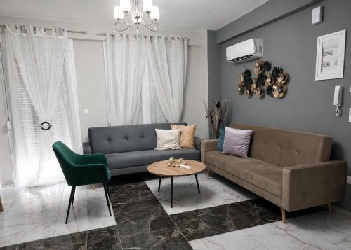 a living room with a couch and a table at Duba Apartments 2 in Alexandroupoli