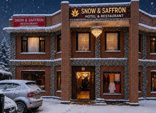 a snow covered building with a hotel and restaurant at Snow and Saffron Hotel & Restaurant in Khor