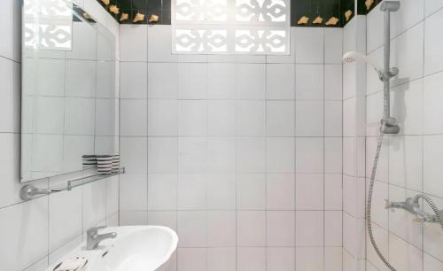 a white bathroom with a sink and a shower at Chaiyo Riverfront Resort Phuket in Phuket