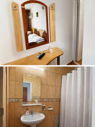a bathroom with a sink and a mirror at Vila Flavia in Costinesti