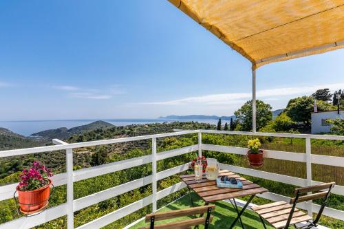 a view from the balcony of a house with a table and chairs at Pastalia Cottage in Skopelos Town