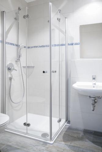 a bathroom with a shower and a sink at Rote Villa Füssen in Füssen
