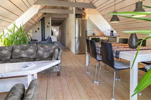 a living room with a couch and a table at The Aspö Hideaway in Drottningskär