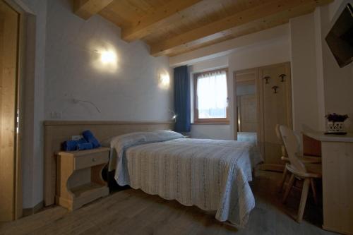מיטה או מיטות בחדר ב-Agricampeggio Ai Gaggi