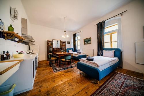 a kitchen and living room with a couch and a table at Penzion Sborovna in Zbraslavice