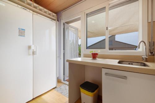 a kitchen with a sink and a window at Casa Gemina in Deltebre