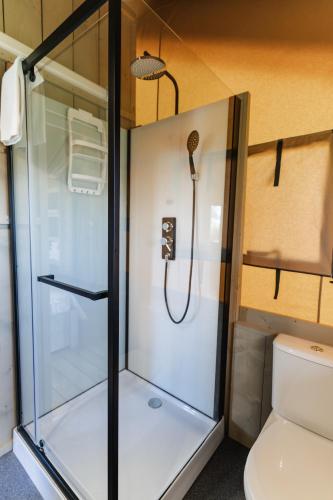 a shower in a small bathroom with a toilet at InMaremma glamping in Pescia Romana