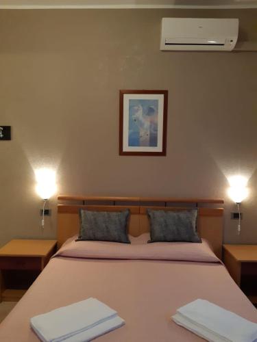a bedroom with a bed with two towels on it at Hotel Ristorante Lilia in Verona