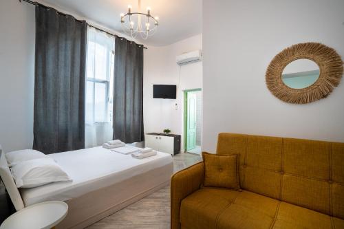 a bedroom with a bed and a chair and a mirror at Hotel Cazino Nord in Mamaia