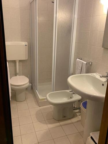 a bathroom with a toilet and a sink at Hotel Ristorante Lilia in Verona