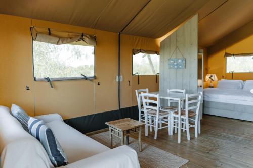 a living room with a couch and a table at InMaremma glamping in Pescia Romana