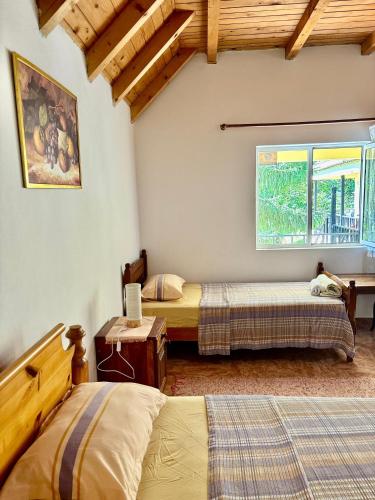 a bedroom with two beds and a window at Bujtina Te Grima in Theth
