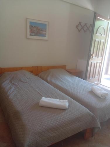 a bedroom with a bed with two towels on it at Evriaki Rooms Lesvos in Gera