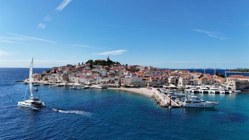 a group of boats in the water near a city at Rooms Bozena in Primošten
