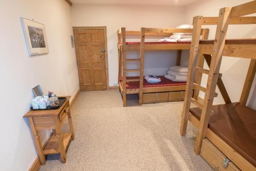 a room with two bunk beds and a table at New Ing Lodge in Shap