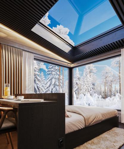 a bedroom with a large window with a bed and a desk at ALVA Resort in Rovaniemi