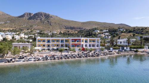 an aerial view of a resort with chairs and water at Alidian bay Suites Leros in Alinda