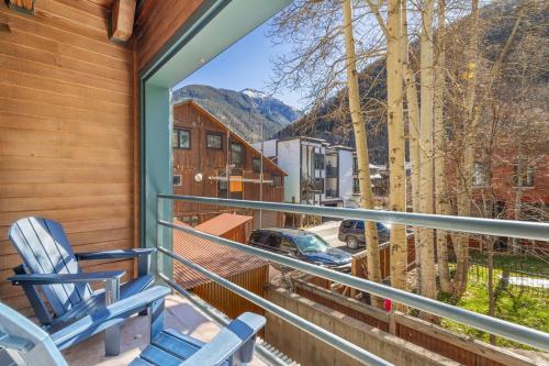 a balcony with a chair and a view of a street at Fall Line 107 in Telluride