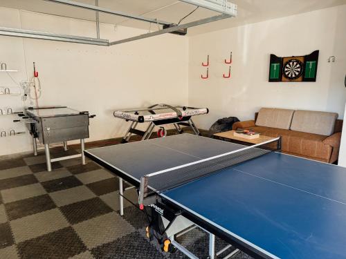 a room with a ping pong table and a couch at Chata Hana Donovaly in Donovaly
