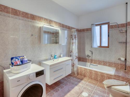 a bathroom with a sink and a washing machine at Azure Seaside Living in Kardamaina