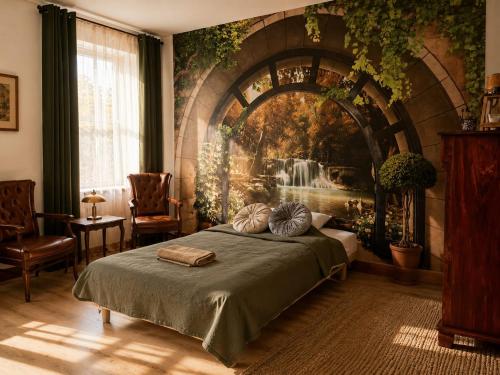 a bedroom with a bed and a large painting on the wall at Apartamenty Sunny Bear in Jelenia Góra