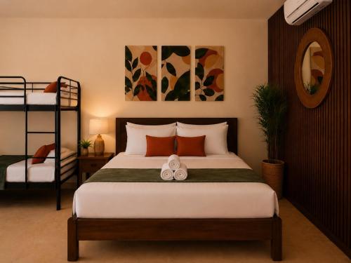 a bedroom with a bed and two bunk beds at Nora's Place in Panglao Island