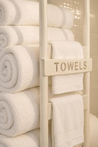 a stack of towels on a rack in a bathroom at Puntabraccetto Sunset in Santa Croce Camerina