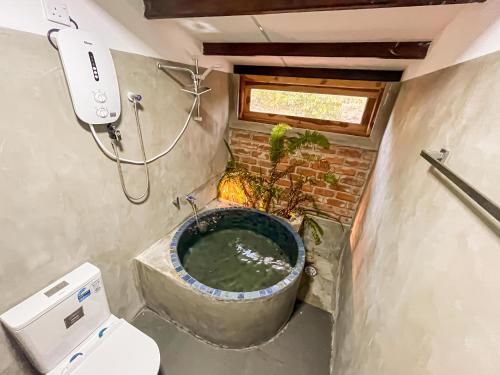 a bathroom with a bath tub and a toilet at Mahagedara Villa Wilpattu in Nochchiyagama