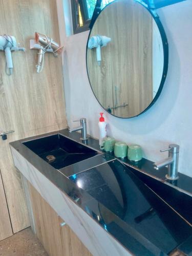 a bathroom with a sink and a mirror at Mây Villa HA in Yên Bài