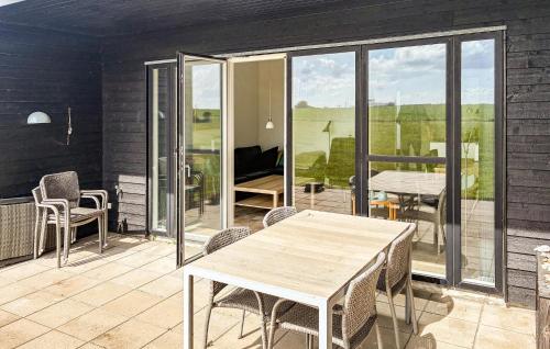 a patio with a table and chairs on a balcony at 2 Bedroom Nice Apartment In Samsø in Ballen