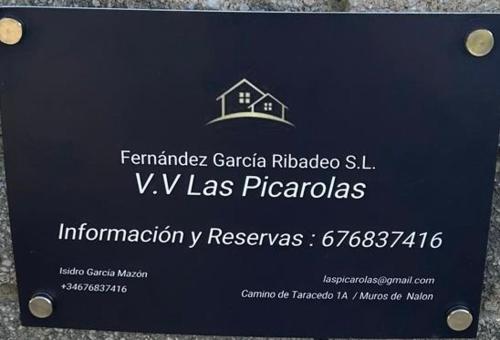 a sign with a house on top of it at VV Las Picarolas in Muros de Nalón