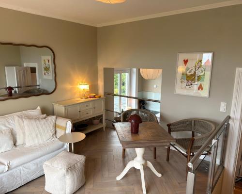 a living room with a couch and a table at Seaside Apartments Austernbank in Cuxhaven