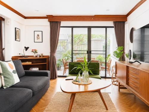 a living room with a couch and a table at Pannarai's House in Bangkok
