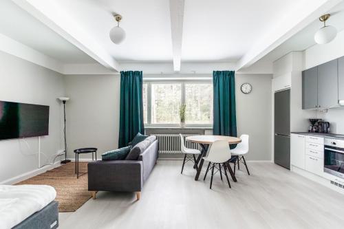 a living room with a couch and a table at Spot Apartments Hyrylä in Hyrylä