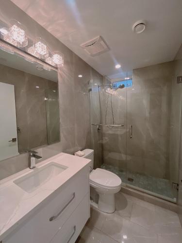 a bathroom with a toilet sink and a shower at Claire House in Vancouver