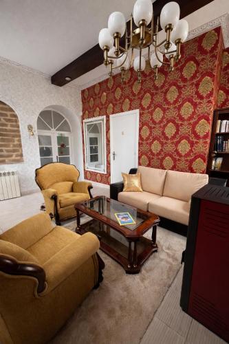 a living room with a couch and chairs and a table at Palacete da Vermelha in Vermelho