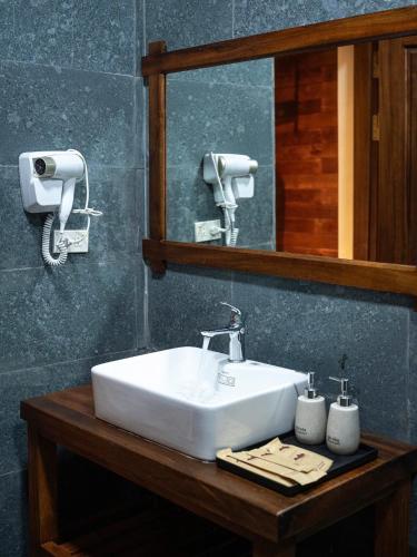 a bathroom with a white sink and a mirror at Mai Homestay in Ninh Binh