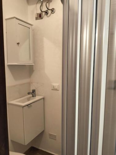 a bathroom with a shower and a sink at Outside the Townhall in Piombino