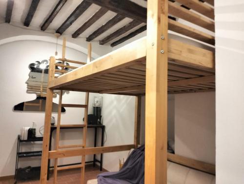 a bunk bed in a room with a ladder at Outside the Townhall in Piombino