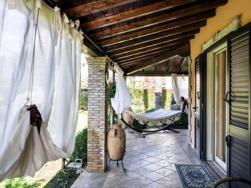 a porch with a hammock on a house at Villa Di Marmo in Trappitello