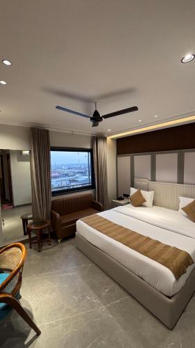 a large bedroom with a large bed and a couch at Hotel Classic in Pānīpat