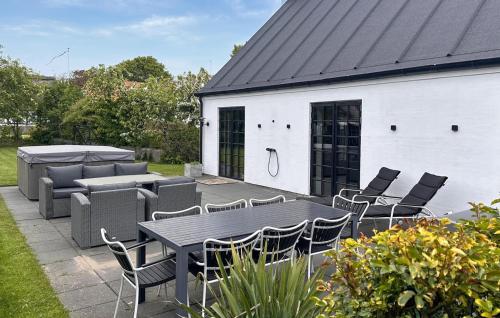 a patio with a table and chairs and a building at Gorgeous Home In Samsø With Wifi in Nordby