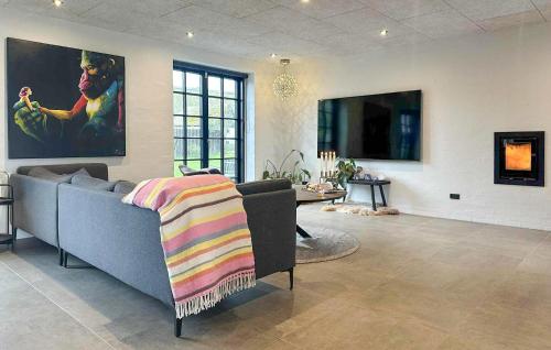a living room with a couch and a table at Gorgeous Home In Samsø With Wifi in Nordby