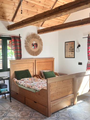 a bedroom with a large wooden bed in a room at Rozkoszne Roztocze - domek na wynajem in Staw Noakowski