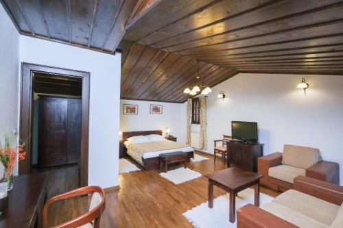 a living room with a bed and a couch at Hotel Ivanov Konak i Depadans Palac in Cetinje