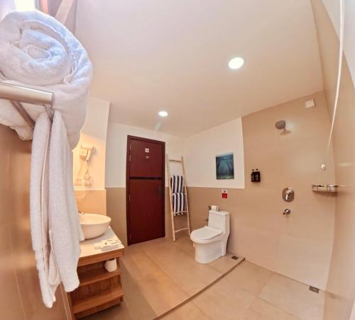 a bathroom with a toilet and a sink at Cocomo Maldives in Himmafushi