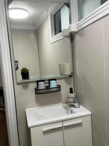 a bathroom with a sink and a mirror at Pátio de Alfama in Lisbon